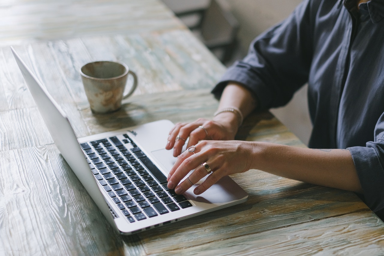 man tying on a laptop