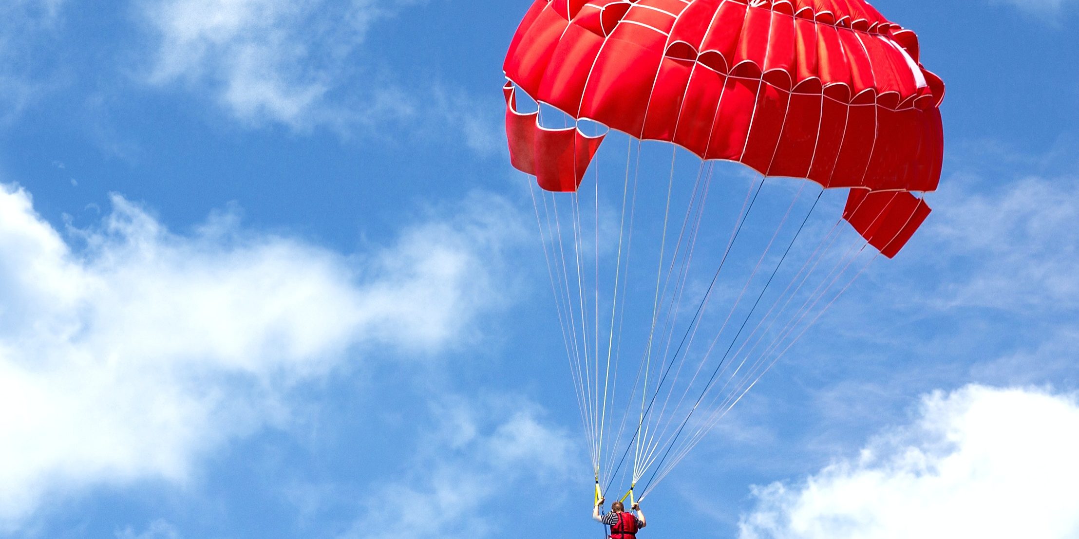 bright parachute on blue sky